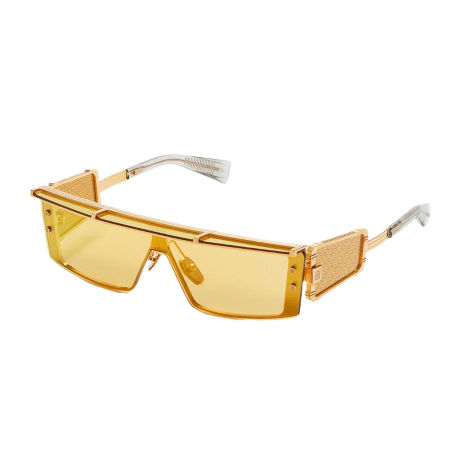 Amber with gold toned titanium  Rectangular shape Balmain Logo on temples Amber tinted lenses 100% UV protection Made in Japan Case and lens cloth included