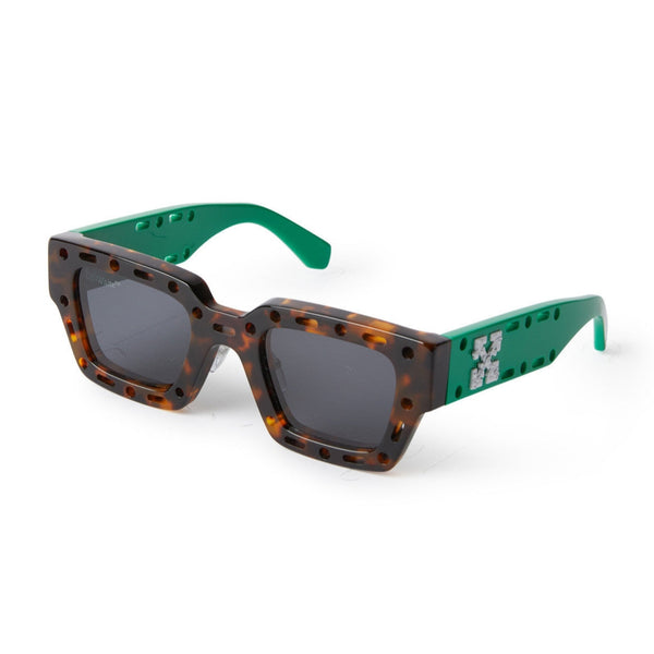 Havana acetate front with green temples Rectangular shape enhanced with geometric cut outs Contrast logo on temples Gray tinted lenses 100% UV protection Made in Italy Case and lens cloth included