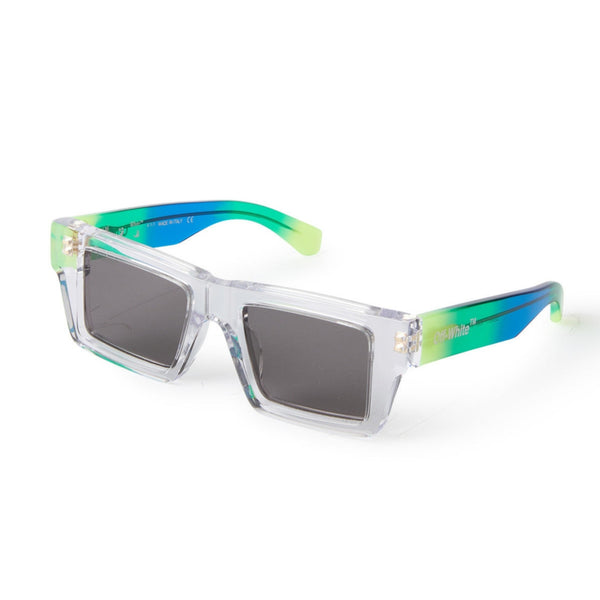 Clear acetate front with multi colored temples Rectangular shape Lasered logo on temples Gray tinted lenses 100% UV protection Made in Italy Case and lens cloth included